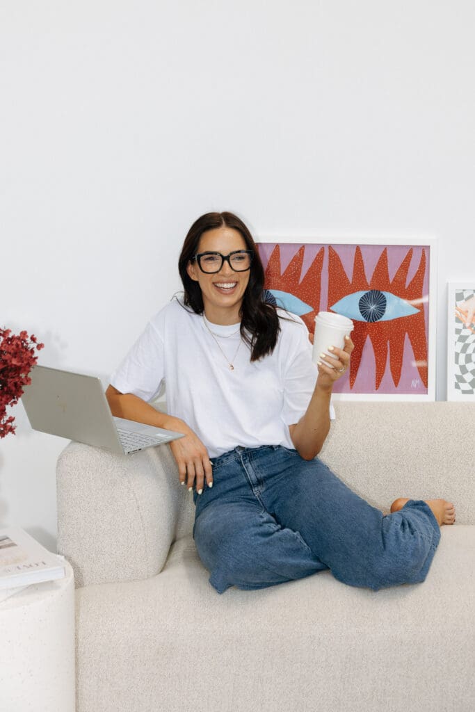 Aimee from Coja Creative at Studio Sohl in Warrnambool Victoria. Lounge room setting. Holding a coffee cup.