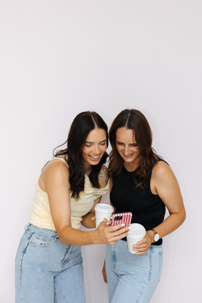 Aimee and Ash from Coja Creative in front of the pink backdrop at Studio Sohl in Warrnambool Victoria